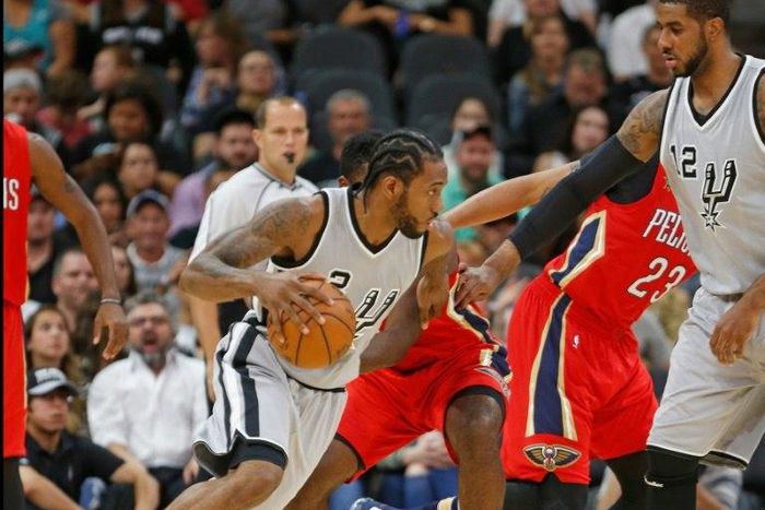 Kawhi Leonard of the San Antonio Spurs drives as teammate LaMarcus Aldridge prepares to set a screen during their NBA game against the New Orleans Pelicans, at AT&T Center in San Antonio, Texas, on October 29, 2016