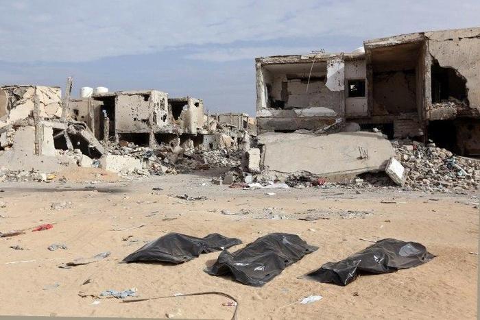 Body bags on the ground after being pulled from rubble by the Libyan Red Crescent in Sirte, on December 20, 2016