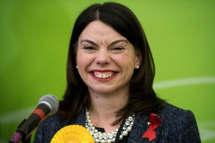 Newly elected Liberal Democrat MP Sarah Olney smiles on stage after winning a by-election in Richmond, southwest London, on December 2, 2016