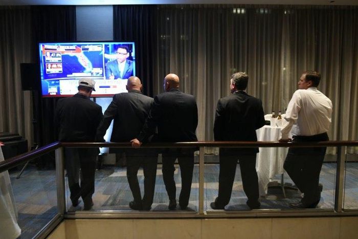 Supporters of Republican presidential nominee Donald Trump watch news reports as results come in during election night at the New York Hilton Midtown in New York
