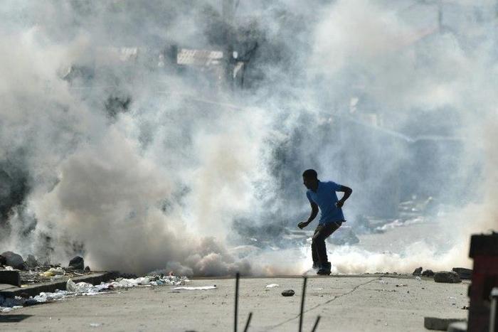 Haiti police fire tear gas as supporters of defeated candidate Maryse Narcisse take to the streets to dispute election results