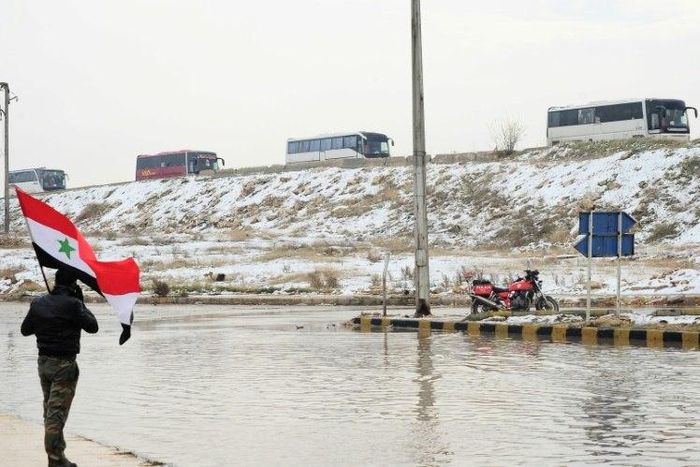 Syrian rebel fighters are evacuated from Aleppo towards rebel-held territory on December 22, 2016