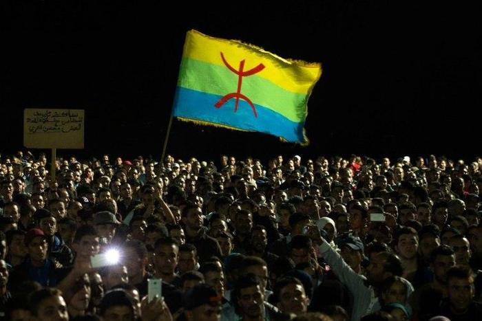 Protesters hold the Amazigh (Berber) flag during a demonstration in the northern Moroccan city of Al-Hoceima on October 30, 2016, following the death of fish seller Mouhcine Fikri