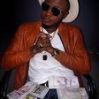 MC Galaxy poses with wads of cash