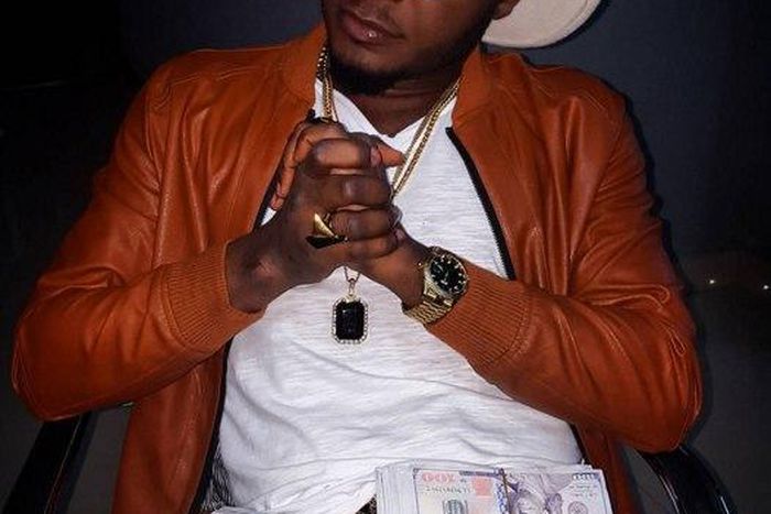 MC Galaxy poses with wads of cash