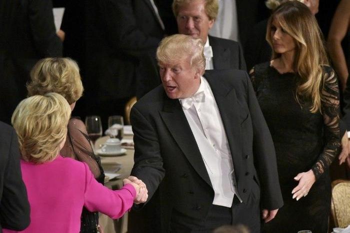Republican presidential nominee Donald Trump shakes hands with Democratic rival Hillary Clinton during the Alfred E. Smith Memorial Foundation Dinner at the Waldorf-Astoria Hotel in New York, on October 20, 2016
