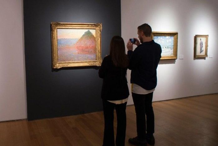 Journalists take a video of "Meule" by Claude Monet in New York during a press preview at Christie's
