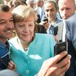 An asylum seeker takes a selfie with Angela Merkel in Berlin
