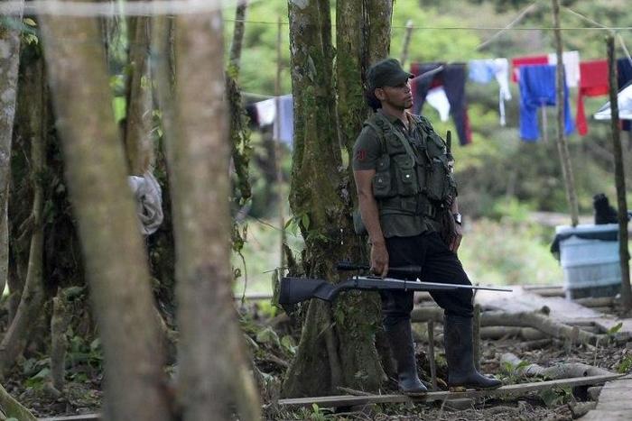 FARC guerrilla fighters stand at the Front 34 Alberto Martinez encampment in Vegaez municipality, Colombia on January 1, 2017