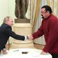 Vladimir Putin (left) shakes hands with Steven Seagal after presenting him with a Russian passport during a meeting at the Kremlin in Moscow, on November 25, 2016