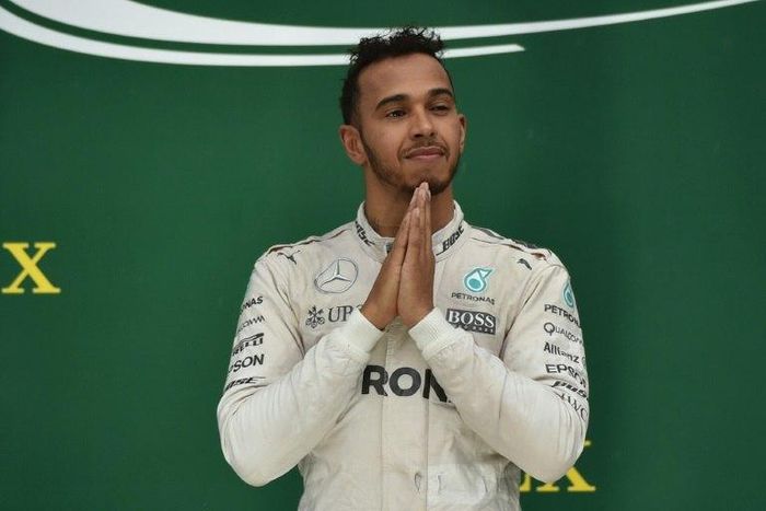Mercedes AMG Petronas F1 Team's British driver Lewis Hamilton on the podium after winning the Brazilian Grand Prix at the Interlagos circuit in Sao Paulo, Brazil, on November 13, 2016