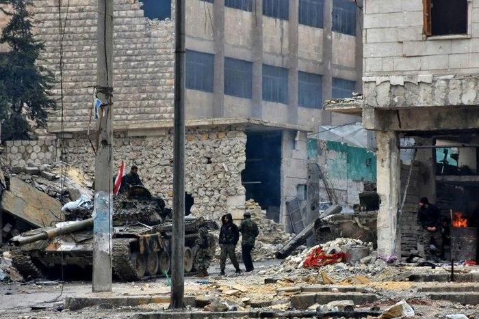 Syrian pro-government forces advance in the Jisr al-Haj neighbourhood during the ongoing military operation to retake remaining rebel-held areas in the northern embattled city of Aleppo on December 14, 2016