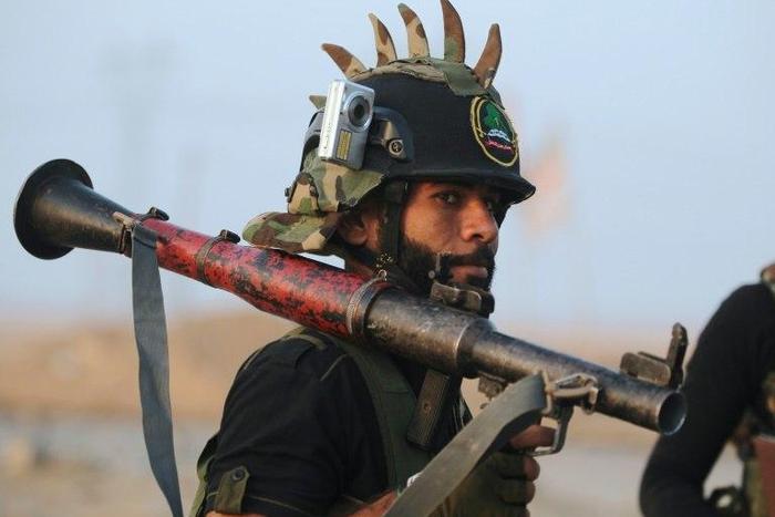 A Shiite fighter from the Hashed al-Shaabi (Popular Mobilisation) patrols in the village of Ayn Nasir, south of Mosul, on October 29, 2016, after it was recaptured from IS group jihadists