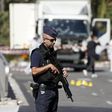 French police secure the area as the investigation continues at the scene near the heavy truck that ran into a crowd at high speed killing scores who were celebrating the Bastille Day July 14 national holiday on the Promenade des Anglais in Nice, Franc...