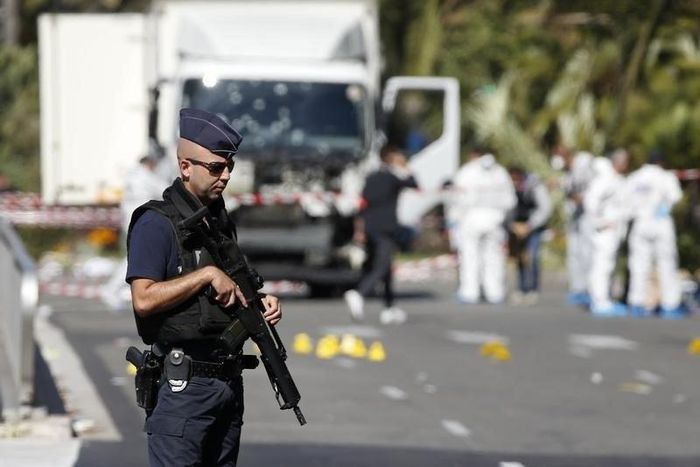 French police secure the area as the investigation continues at the scene near the heavy truck that ran into a crowd at high speed killing scores who were celebrating the Bastille Day July 14 national holiday on the Promenade des Anglais in Nice, Franc...