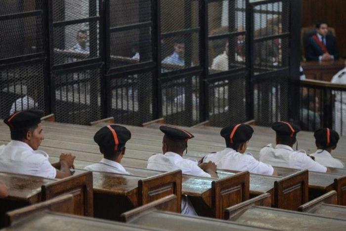 Policemen in court during the trial of 23 people charged over the September killing of police general Nabil Farrag in Kerdassa, considered to be a Muslim Brotherhood stronghold, in Cairo, on June 18, 2014