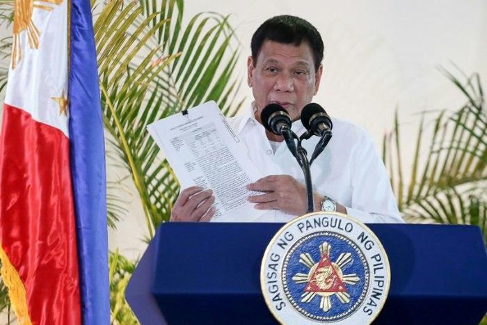 Philippine President Rodrigo Duterte delivers a speech at Davao airport on the southern island of Mindanao on November 17, 2016