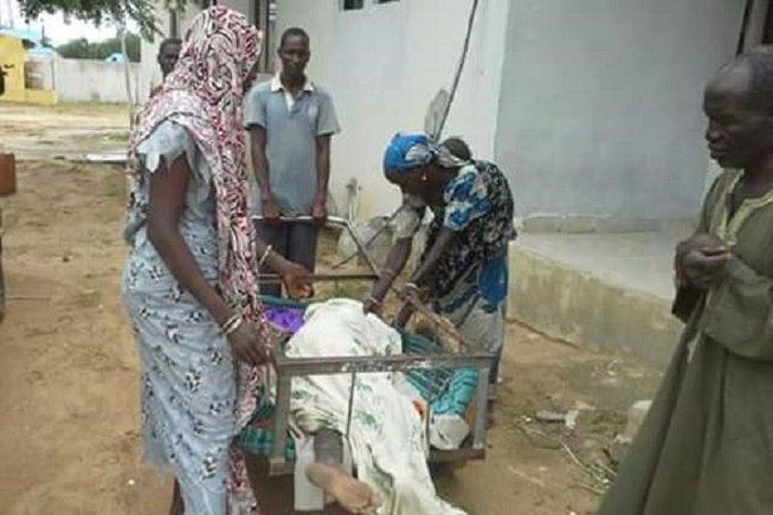 The corpse being transported in a wheelbarrow