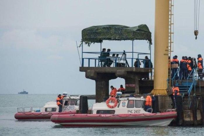 Russian rescuers gather along the shores of the Black Sea at Sochi the day after a Russian military plane crashed, on December 26, 2016