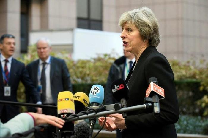 British Prime Minister Theresa May addresses the media as she arrives for an EU leaders' summit in Brussels on December 15, 2016