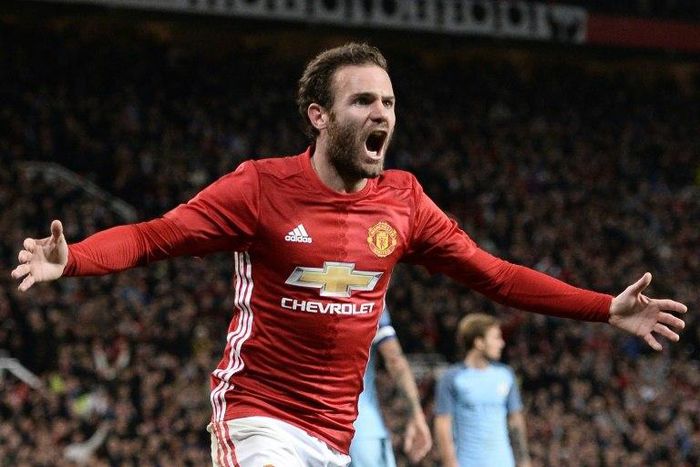 Manchester United's Spanish midfielder Juan Mata celebrates after scoring the opening goal of the English Football League Cup fourth round match between Manchester United and Manchester City on October 26, 2016