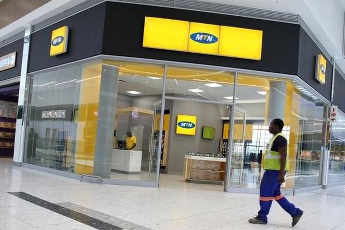 A worker walks past an outlet of South Africa's MTN Group in Johannesburg, South Africa, February 23, 2016. REUTERS/Siphiwe Sibeko/File Photo
