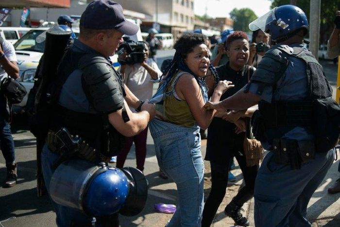 A student from the University of the Witwatersrand (Wits) is detained by South African police forces following clashes during a protest against the university fee increase on September 21, 2016 in Johannesburg