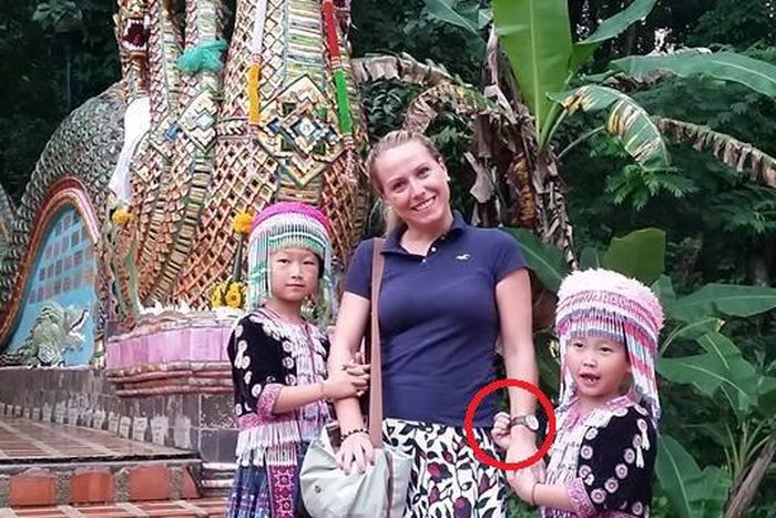 Photo of tourist being robbed by kids