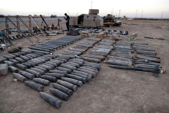Ammunition, a homemade armoured car and mortars launchers confiscated from Islamic State group jihadists are displayed on the ground in the town of Qaraqosh, 30 kms east of Mosul, after Iraqi forces recaptured it from the group