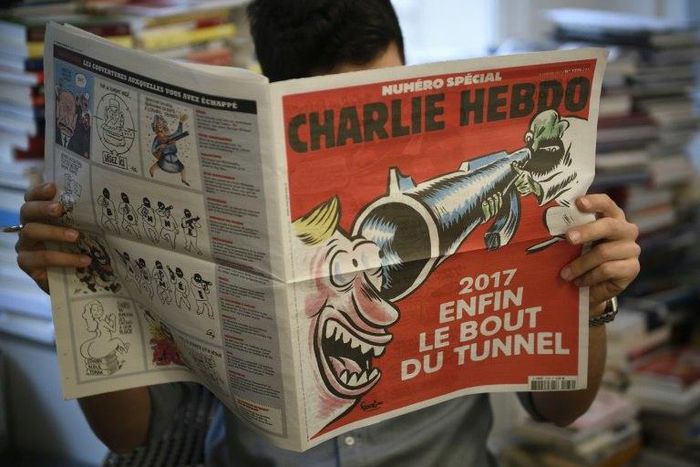 Charlie Hebdo marked the grim anniversary of the terror attack on its staff in typical style with a front-cover cartoon showing a laughing man staring down the barrel of a jihadist's rifle