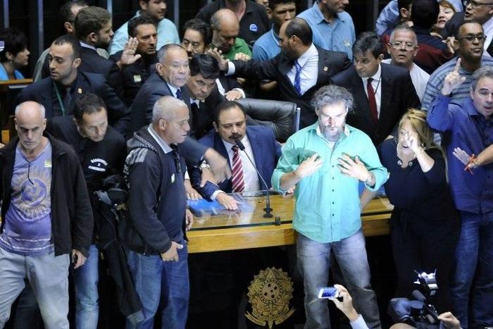 Some 40 people swept past security guards and broke a glass door to invade Brazil's legislative chamber to demand a military coup
