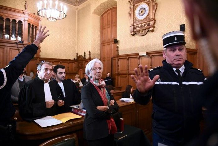 IMF chief Christine Lagarde (C) has been charged with negligence over the settlement with tycoon Bernard Tapie