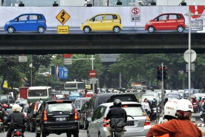 The X-rated clip was seen by motorists as they crawled along the major road in Jakarta