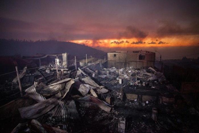 A wildfire ravaged woods before spreading into the Chilean port city of Valparaiso and destroying 100 homes