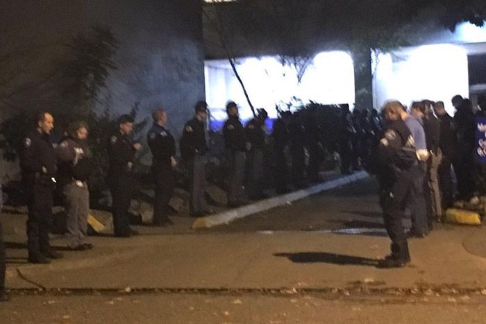 Dozens of uniformed officers from multiple jurisdictions waited in silence at hospital