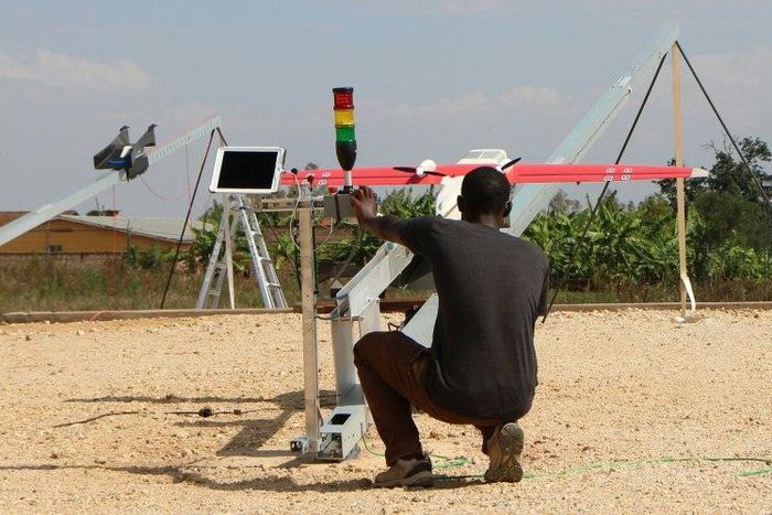 A technician of California-based robotics company Zipline launches a drone in Muhanga, west of the capital Kigali on October 12, 2016