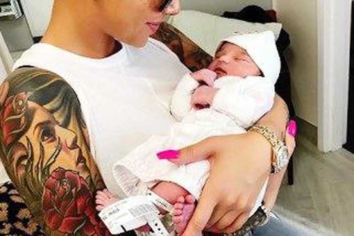 Amber Rose cradling Dream Renee Kardashian