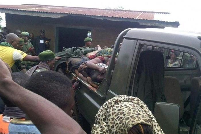 People gather around a truck transporting the victims of a wave of unrest and violence in Beni, Democratic Republic of Congo, in August 2016