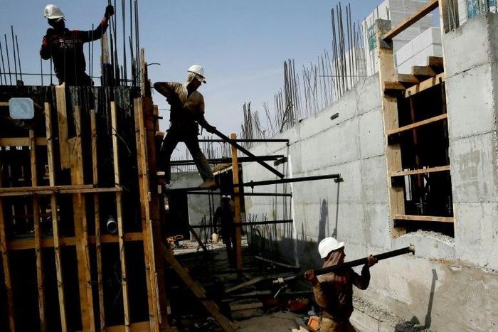 Palestinian laborers work on a construction site in Ramat Shlomo, a Jewish settlement in the mainly Palestinian eastern sector of Jerusalem