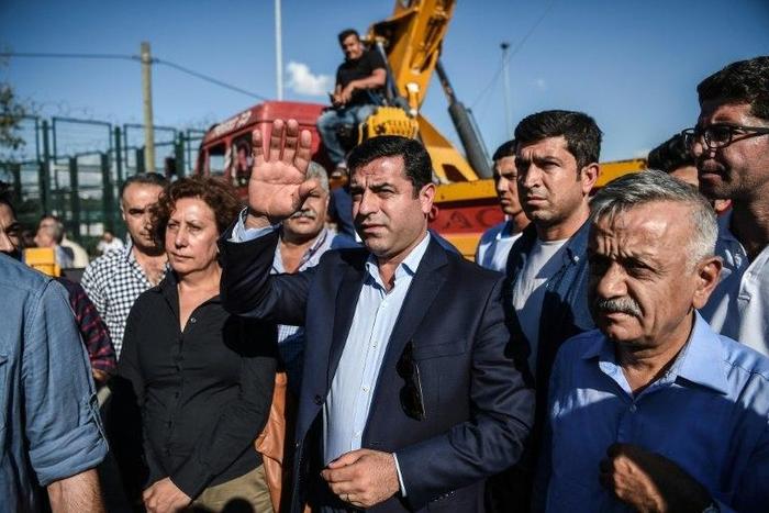 Pro-Kurdish Peoples' Democratic Party leader Selahattin Demirtas waves during a peace rally against the war in Syria on September 4, 2016 in Istanbul