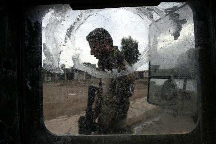 An Iraqi soldier takes position in the village of Gogjali on November 2, 2016