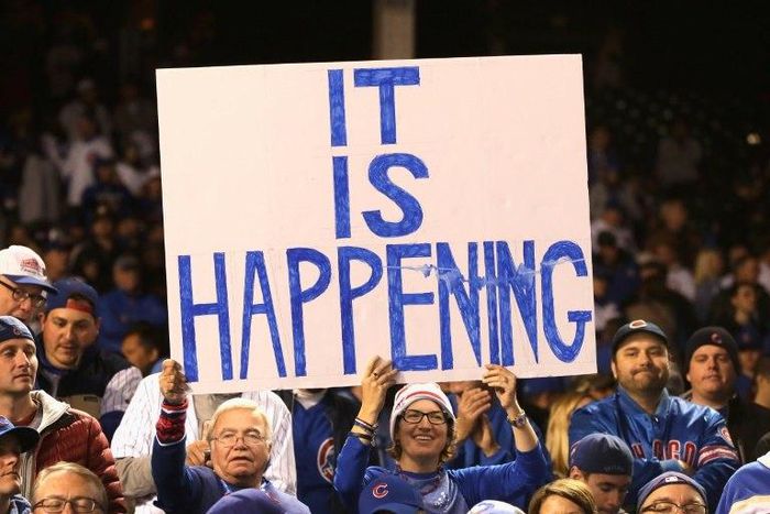 Chicago Cubs fans hold a sign after the Cubs defeated the Los Angeles Dodgers 5-0 to advance to the World Series for the first time in 71 years