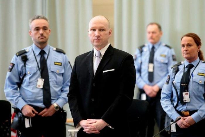 Norwegian mass killer Anders Behring Breivik, surrounded by prison guards, attends his fourth and last day in court in Skien prison, March 18, 2016