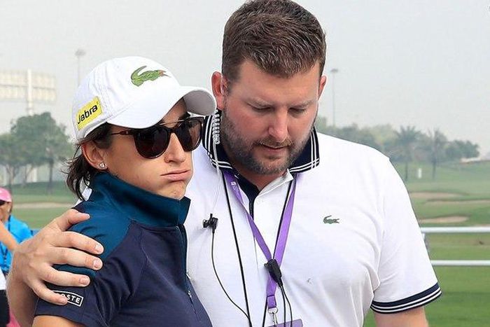 Anne-Lise Caudal is consoled by Tournament Director Michael Wood after her caddie collapsed and later died
