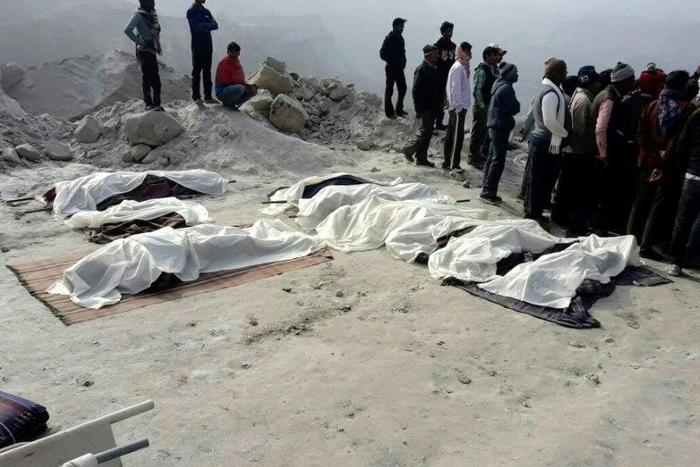 The covered bodies of dead miners lie near the site of a coal mine collapse near Lalmatia in Godda district, in eastern India's Jharkhand state on December 30, 2016
