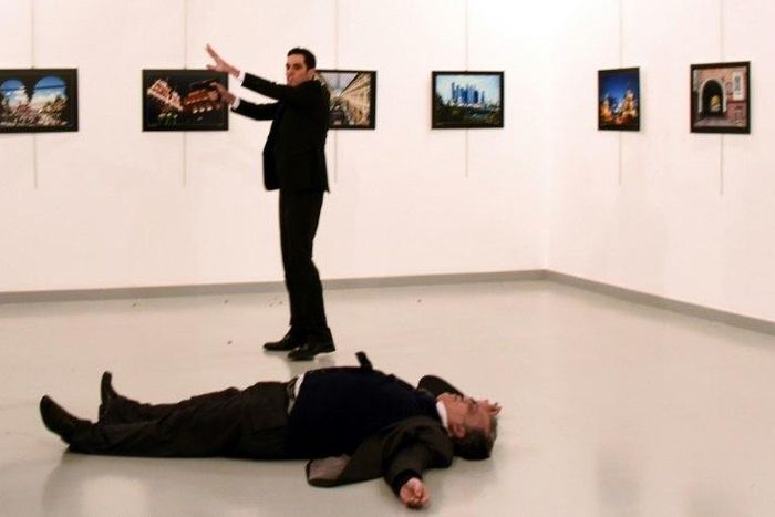 Andrei Karlov (front), the Russian ambassador to Ankara, lies on the floor next to his killer during an art exhibition in Ankara, on December 19, 2016
