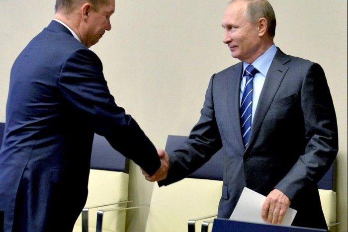 Russian President Vladimir Putin (R) shakes hands with Gazprom CEO Alexei Miller after watching via a live video link the launch operations of the Vostochno-Messoyakhskoye oil field, in Novo-Ogaryovo residence outside Moscow on September 21, 2016