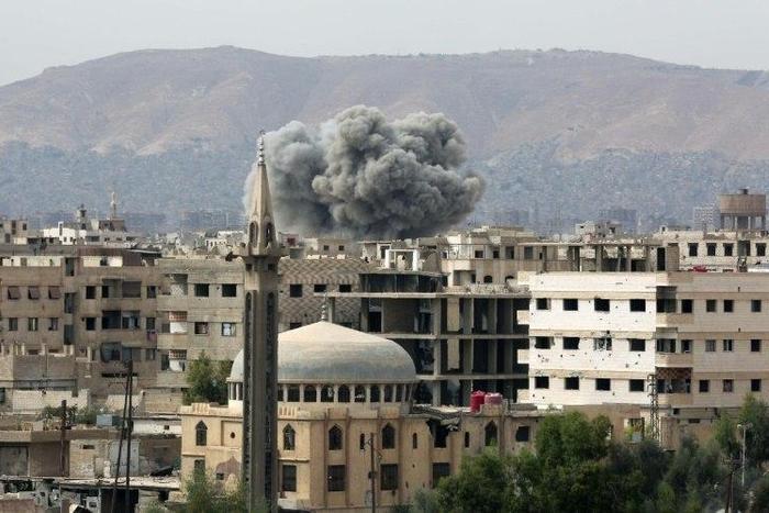 Smoke rises from buildings following air strikes on Damascus' rebel-held eastern suburb of Zamalka on October 12, 2016