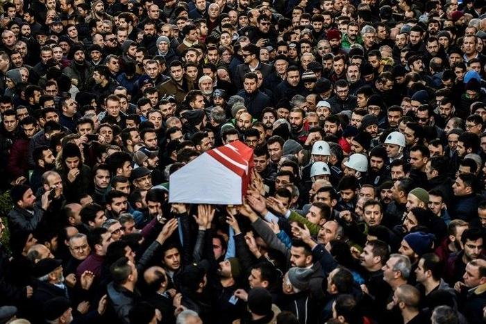 People carry the coffin of Yunus Gormek, 23, one of the victims of the Reina night club attack, during his funeral ceremony on January 2, 2017 in Istanbul