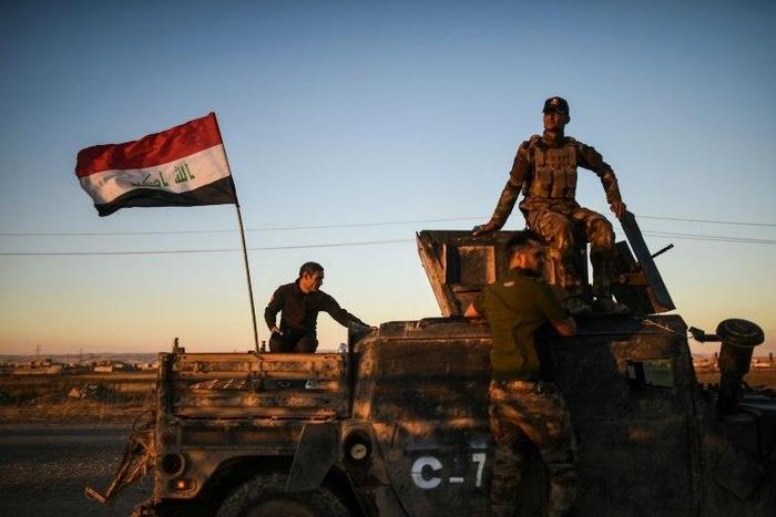 Iraqi forces drive their vehicle near Gogjali, on the eastern edge of Mosul, on November 3, 2016 during their ongoing operation against jihadists of the Islamic State group to retake the city